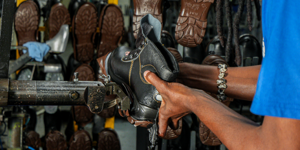 Man sewing shoe
