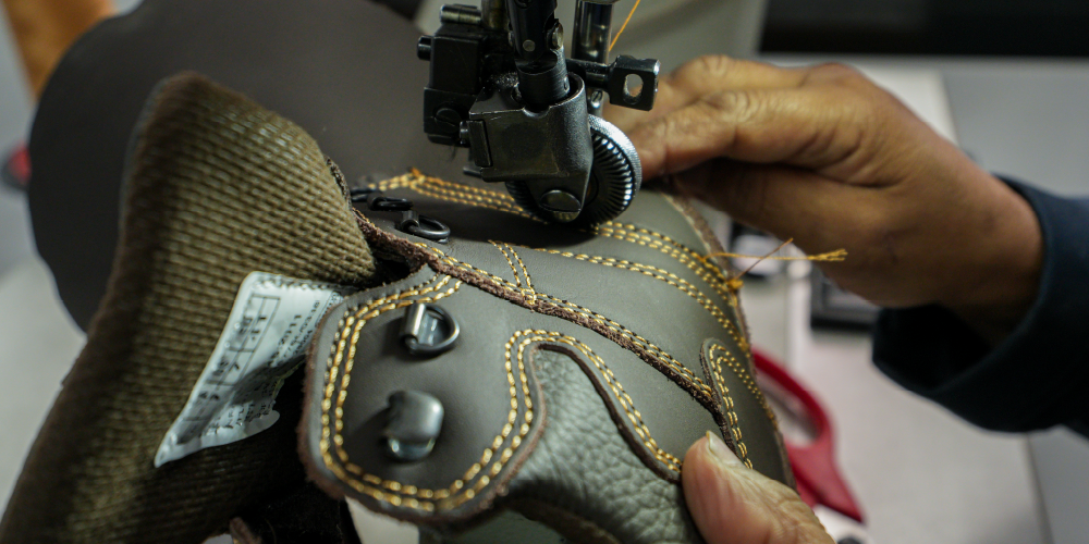 Someone sewing the boot