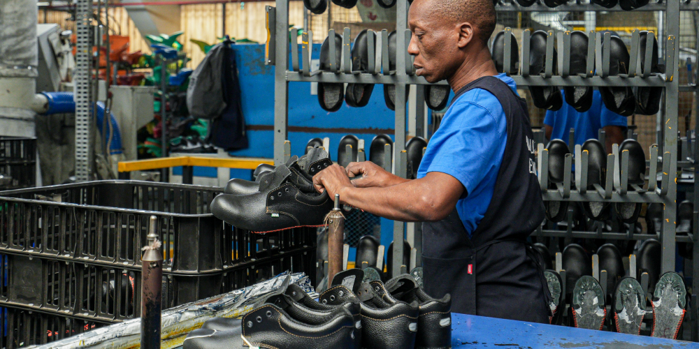 Man sewing shoe